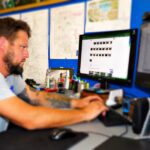 man works at desktop computer | P-Tn