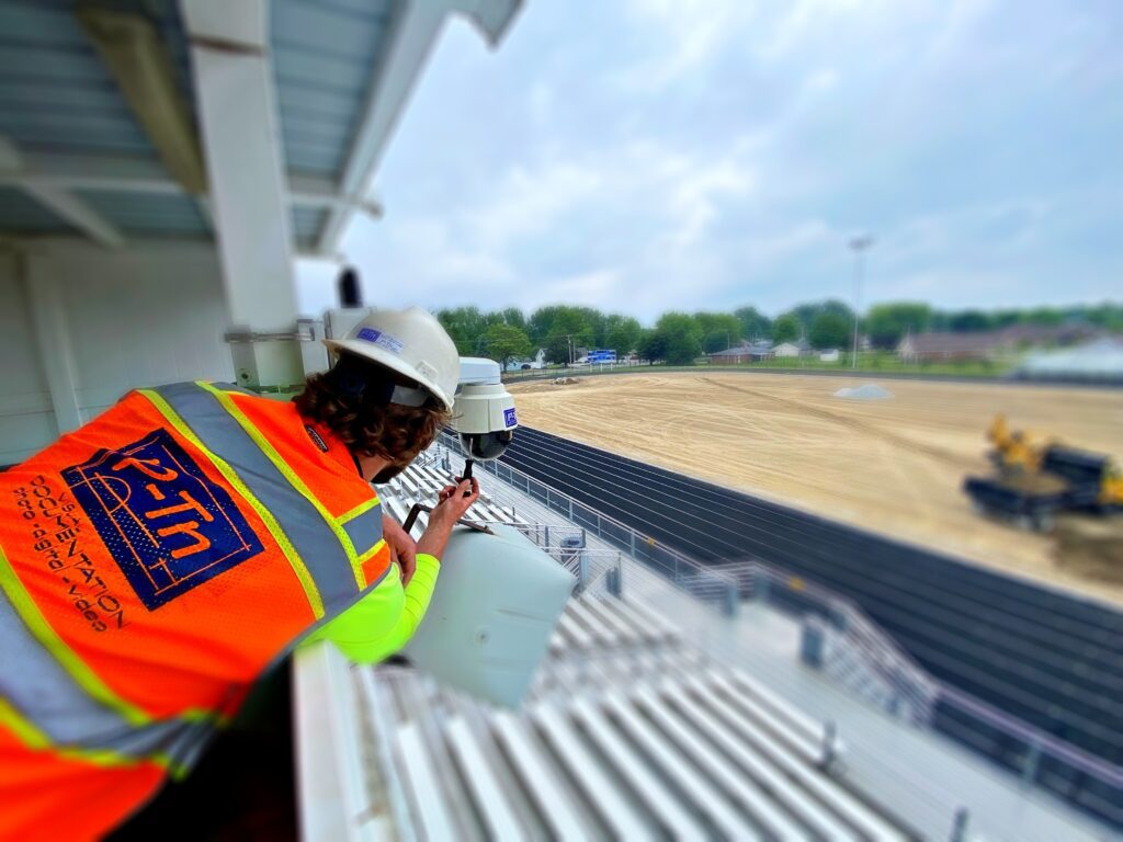Technician install a webcam at an athletic field construction site | P-Tn