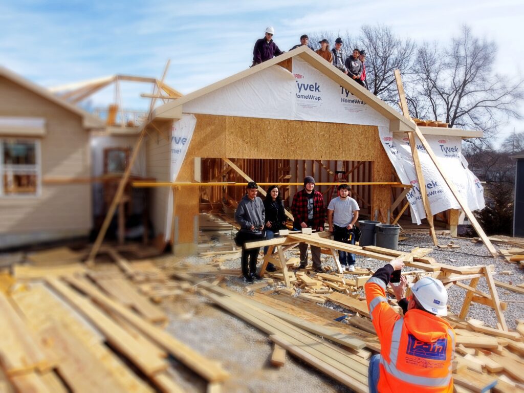 High school students on site at a house for their building trades class | P-Tn