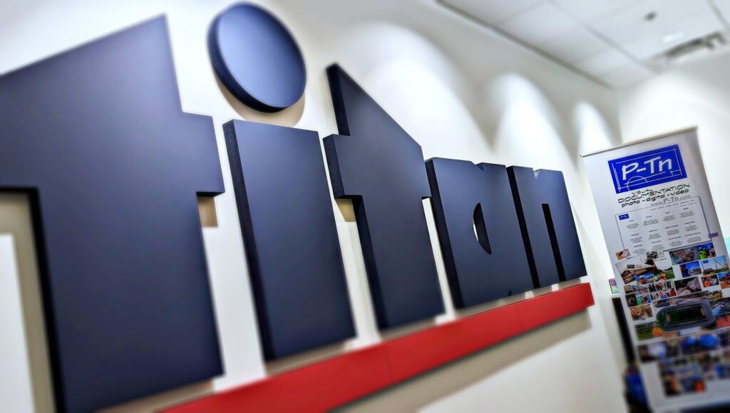 Titan Company logo and P-Tn display banner at office presentation | P-Tn