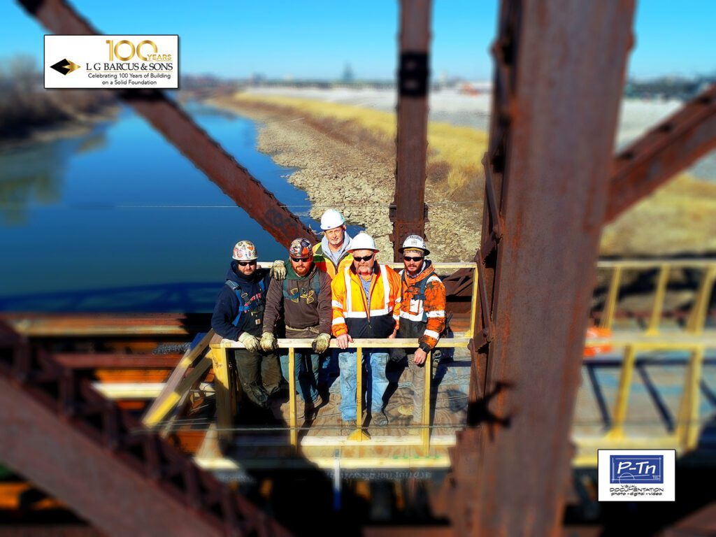 Construction crew standing on truss style railroad bridge in Kansas City - Rock Island Bridge | P-Tn