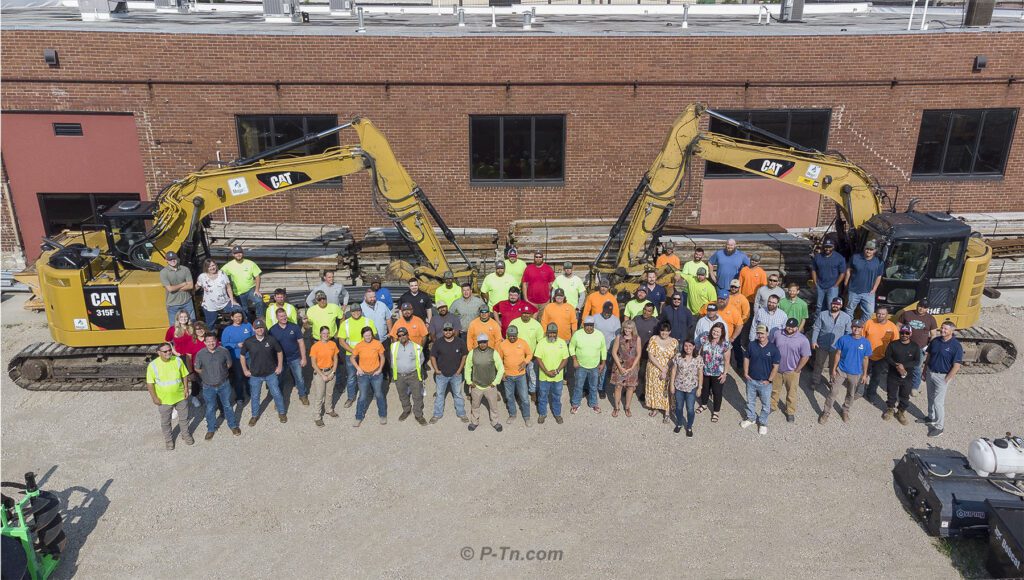May contain a group photo of a construction team. | P-Tn