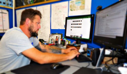 man works at desktop computer | P-Tn